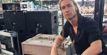 man backstage at concert leaning on VOX amplifier