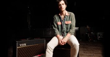 artist, Freddie Cowan, sitting beside VOX amplifier