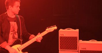artist, Hunter Hayes, playing electric guitar beside VOX amplifiers in concert