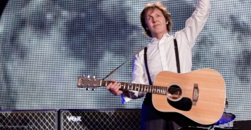 Paul Mccartney holding acoustic guitar