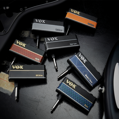 Vox amPlug3 Headphone Guitar Amplifier on the ground with guitar on sides